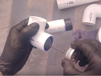 Applying PVC glue to the pvc fitting socket