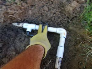 Hold PVC pipe and elbow together until glue sets firm
